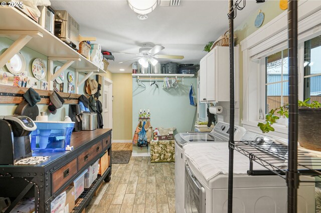 30596 Horseshoe Dr, Albany, OR 97321 - clothes washing area with a ceiling fan, cabinet space, light wood-style flooring, baseboards, and independent washer and dryer