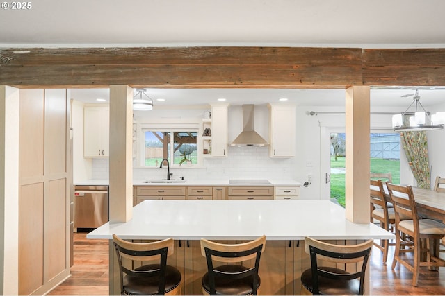 30596 Horseshoe Dr, Albany, OR 97321 - kitchen with backsplash, dishwasher, wall chimney exhaust hood, a kitchen bar, and light wood-style flooring