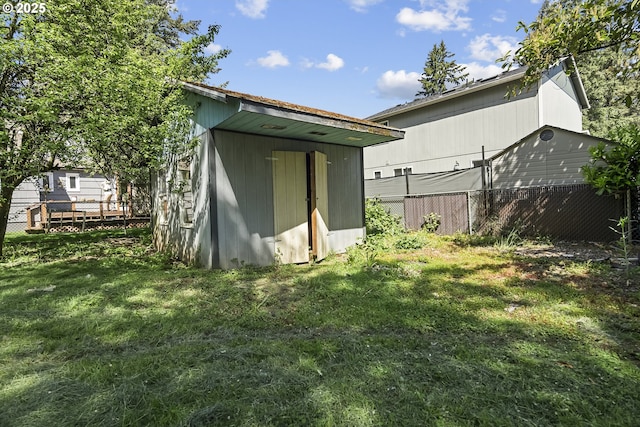 rear view of house with a storage unit and an outdoor structure