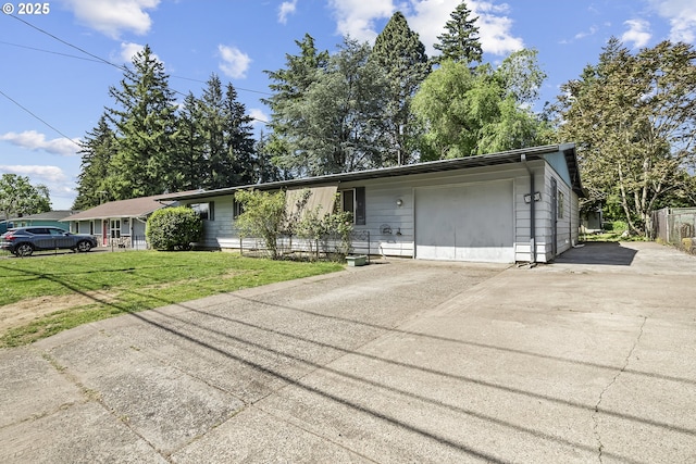 single story home with driveway, a front lawn, and a garage