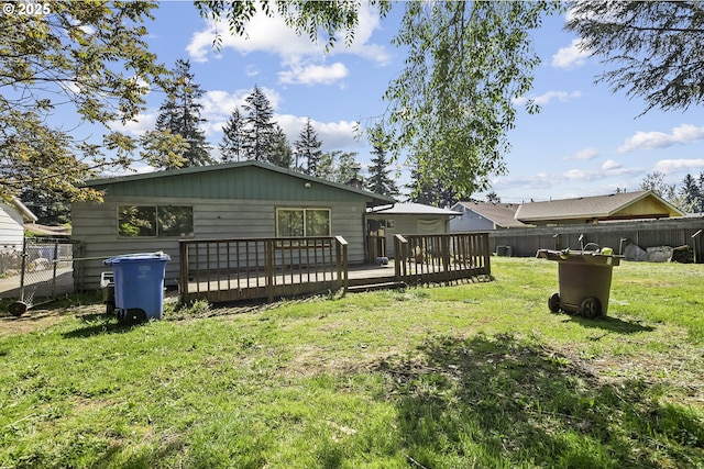 rear view of property featuring a wooden deck