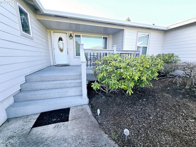 entrance to property featuring a porch