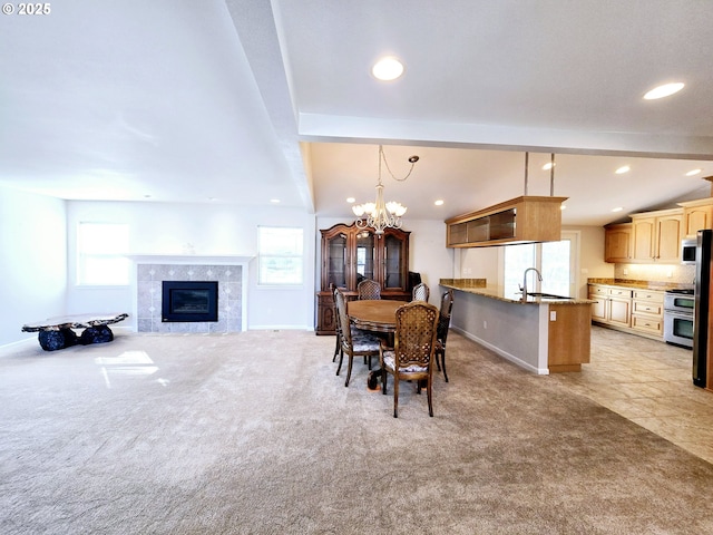 dining area with baseboards, light colored carpet, lofted ceiling with beams, recessed lighting, and an inviting chandelier