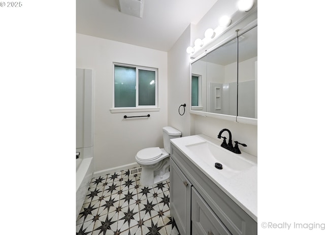 bathroom with vanity, toilet, baseboards, walk in shower, and a bathing tub