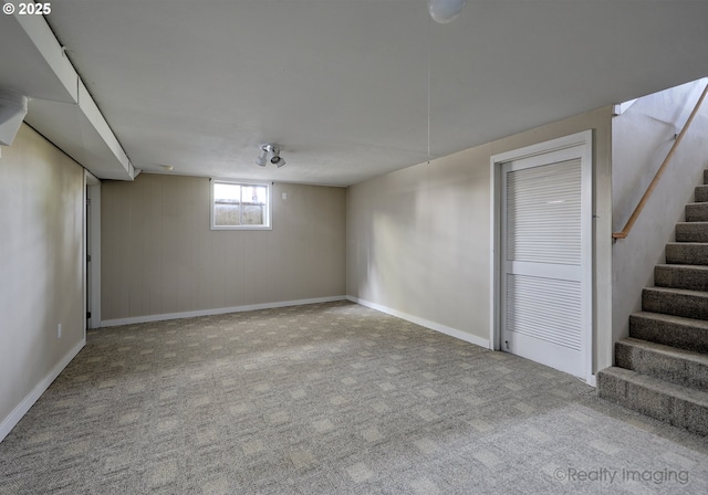 basement with carpet floors, baseboards, and stairs