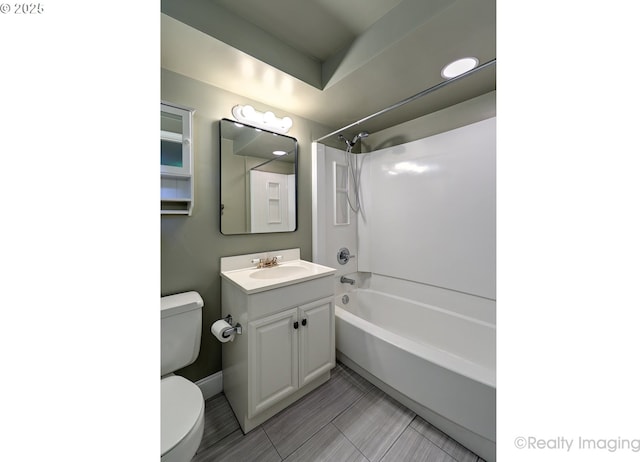 bathroom with vanity, washtub / shower combination, and toilet