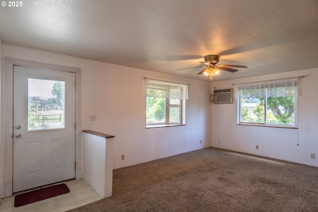 471 Hawthorne St, Sutherlin, OR 97479 - spare room featuring a textured ceiling, an AC wall unit, a ceiling fan, and light carpet
