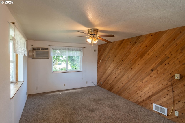 471 Hawthorne St, Sutherlin, OR 97479 - empty room with wooden walls, carpet flooring, a ceiling fan, and an AC wall unit