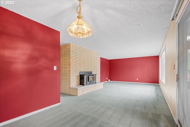 unfurnished living room featuring carpet flooring, baseboards, and a textured ceiling