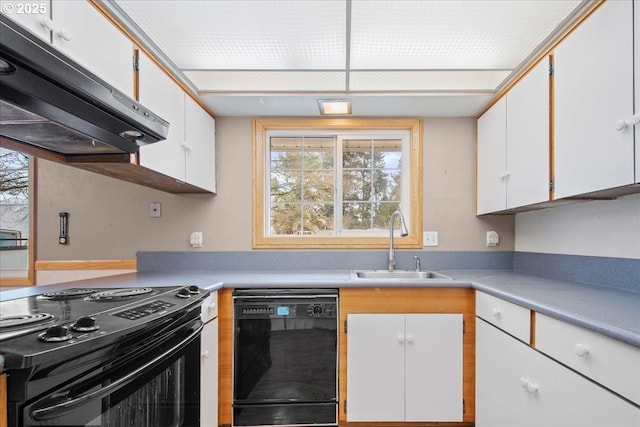 kitchen with under cabinet range hood, black appliances, light countertops, and a sink