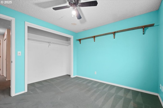 unfurnished bedroom featuring a closet, ceiling fan, a textured ceiling, and carpet