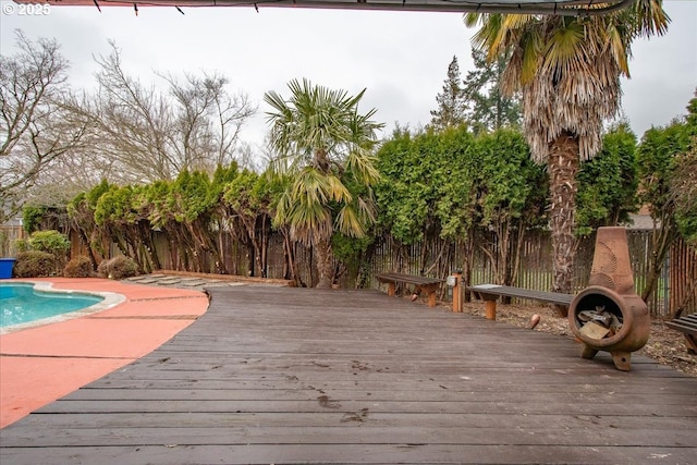 view of pool featuring a fenced in pool, a wooden deck, and fence