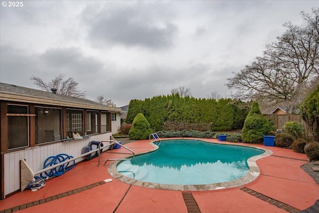 view of swimming pool featuring fence, a patio area, and a fenced in pool