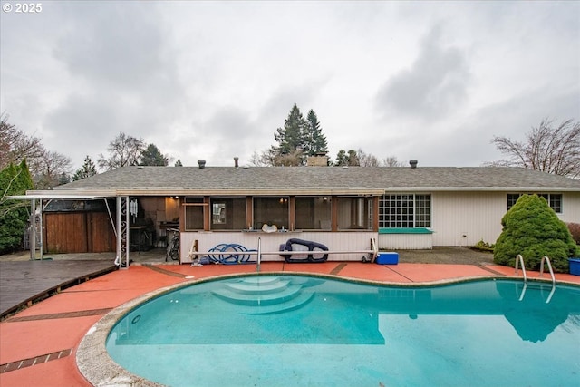 back of house with a patio area, an outdoor pool, and a chimney