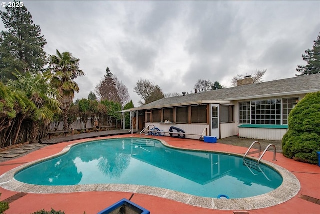 view of swimming pool with a fenced in pool and a patio area