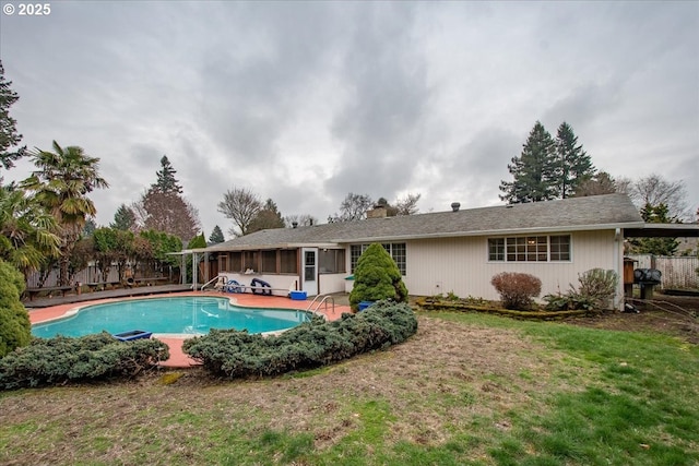 view of pool with a fenced in pool, a lawn, a patio area, and fence