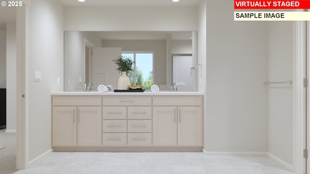 full bathroom with double vanity, baseboards, and a sink