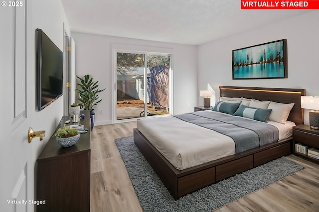 bedroom with light hardwood / wood-style floors and access to outside