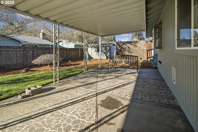 view of patio featuring a storage unit