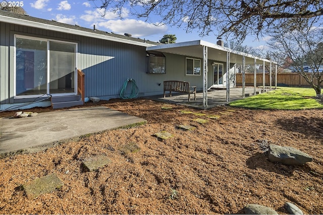 rear view of property with a patio and a lawn