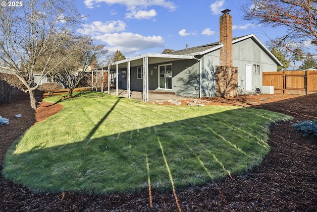 back of property featuring a yard and a patio area