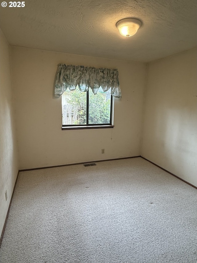 2040 40th St, Florence, OR 97439 - carpeted spare room with a textured ceiling and baseboards