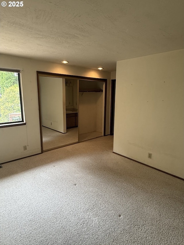 2040 40th St, Florence, OR 97439 - unfurnished bedroom with light carpet, a textured ceiling, and a closet