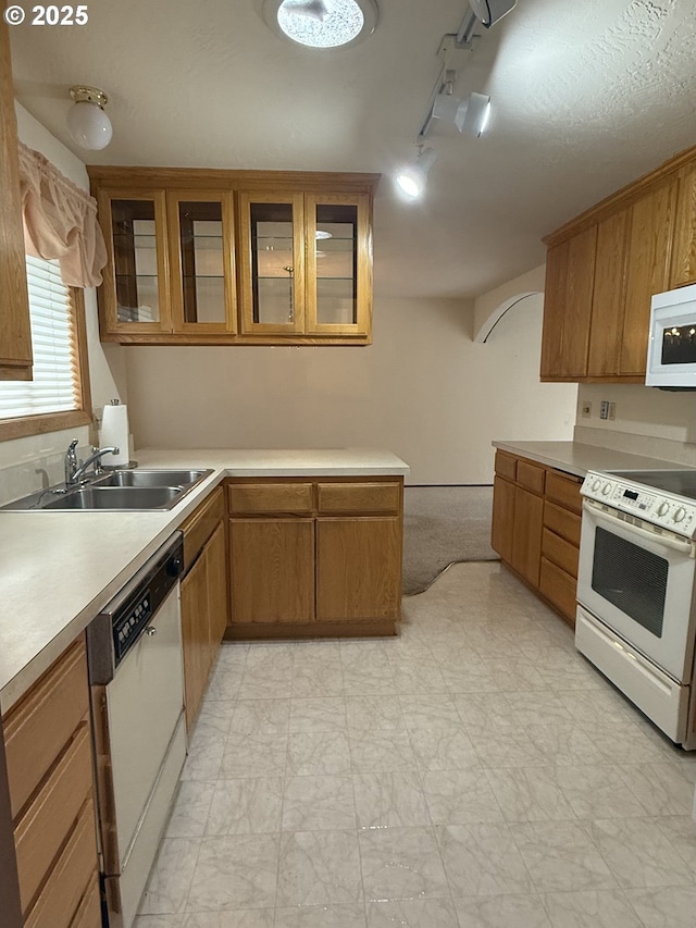 2040 40th St, Florence, OR 97439 - kitchen featuring white appliances, light countertops, track lighting, and brown cabinets