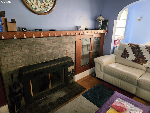 living room featuring a fireplace and dark hardwood / wood-style flooring