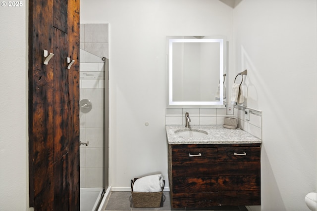 bathroom featuring a stall shower, vanity, and tasteful backsplash