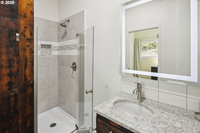 full bath with a shower stall and vanity