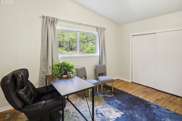 sitting room featuring vaulted ceiling, wood finished floors, and a desk