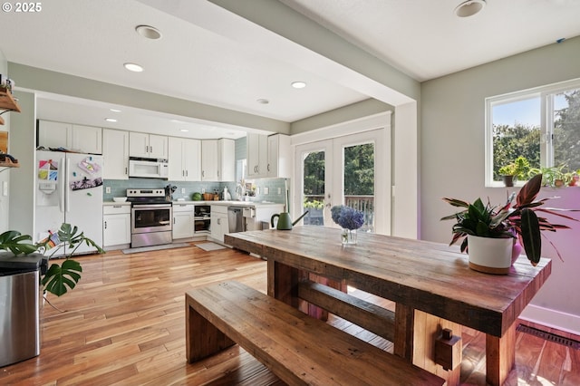 1612 12th St, Oregon City, OR 97045 - dining space featuring french doors, light wood finished floors, and recessed lighting