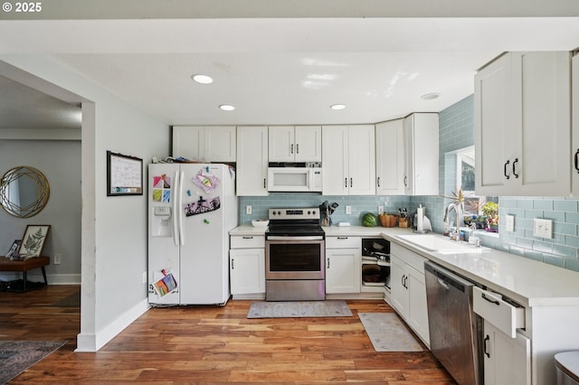 1612 12th St, Oregon City, OR 97045 - kitchen with stainless steel appliances, tasteful backsplash, white cabinetry, and recessed lighting