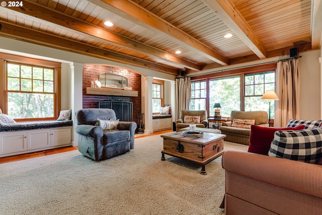 living room with beamed ceiling, a fireplace, light wood-type flooring, and recessed lighting