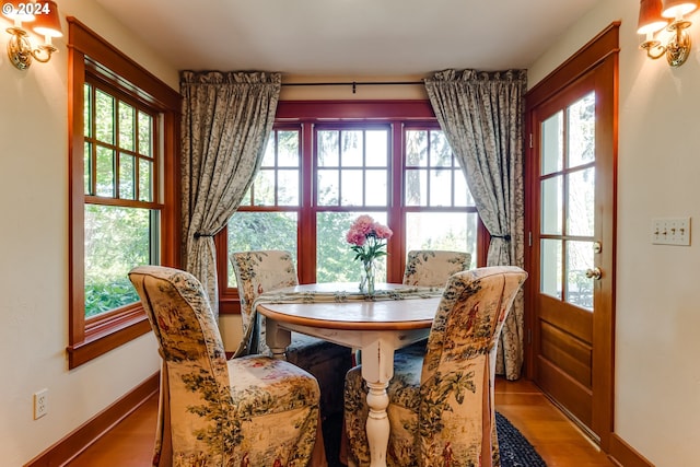 dining area with plenty of natural light, baseboards, and wood finished floors