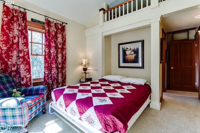 carpeted bedroom with vaulted ceiling