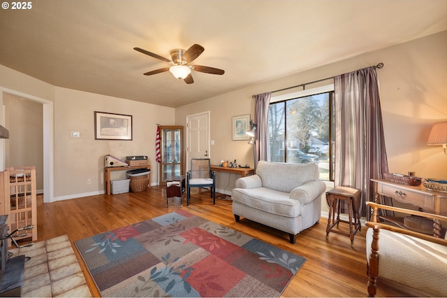 living room featuring ceiling fan and light hardwood / wood-style flooring