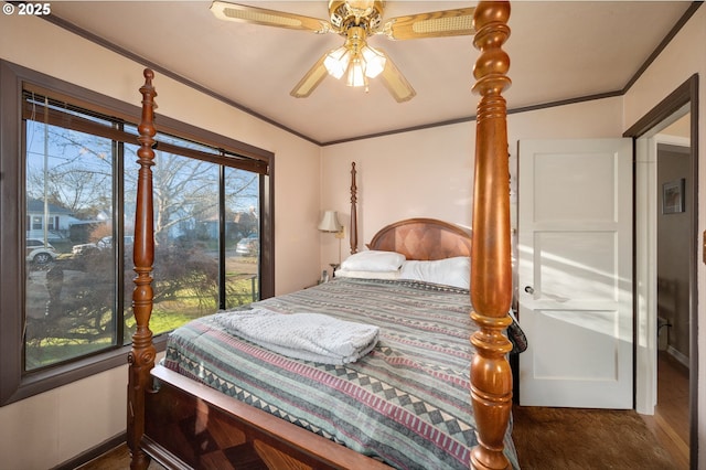 bedroom featuring hardwood / wood-style floors, ornamental molding, and ceiling fan