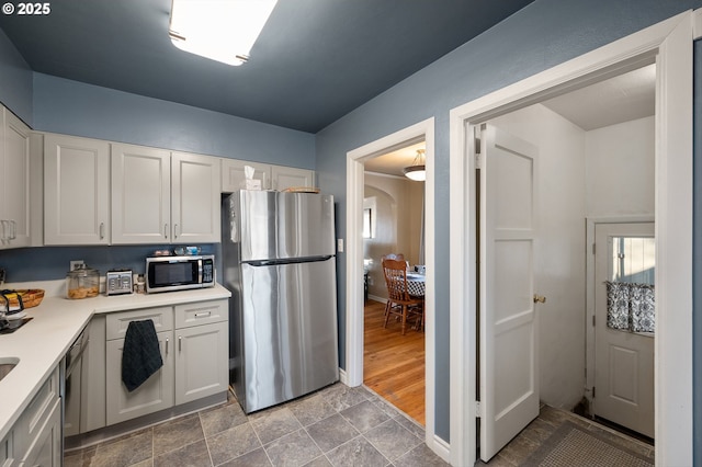 kitchen featuring white cabinetry and appliances with stainless steel finishes