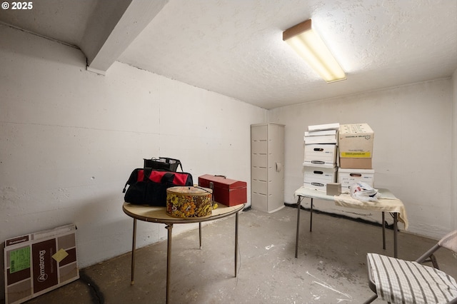 basement featuring a textured ceiling