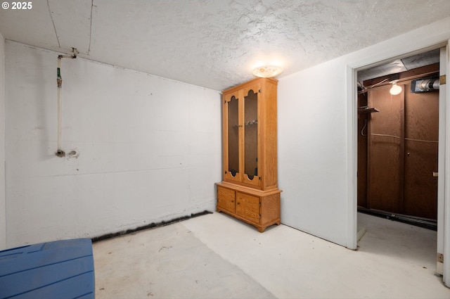 basement featuring a textured ceiling