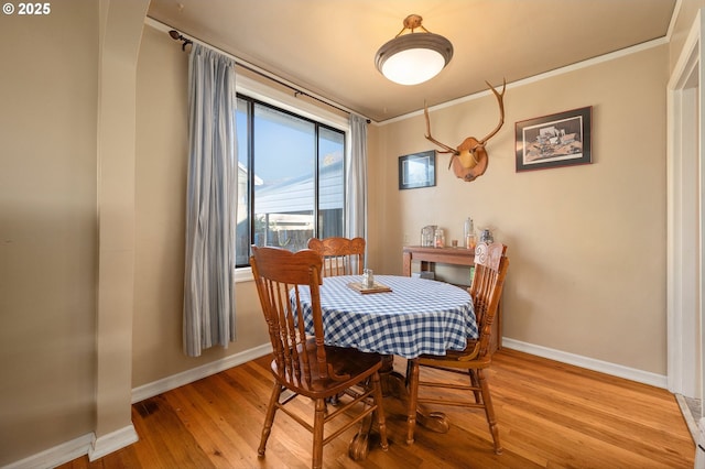 dining space with light hardwood / wood-style floors