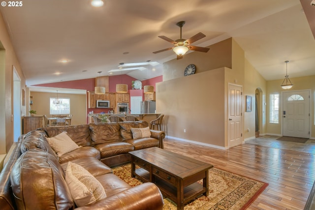 755 NW 23rd St, Pendleton, OR 97801 - living area featuring lofted ceiling, ceiling fan, a chandelier, light wood-style floors, and arched walkways