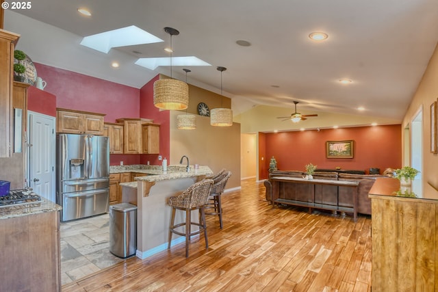 755 NW 23rd St, Pendleton, OR 97801 - kitchen featuring stainless steel fridge, vaulted ceiling, open floor plan, a breakfast bar, and a peninsula