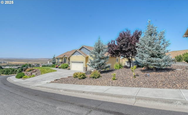 755 NW 23rd St, Pendleton, OR 97801 - view of property hidden behind natural elements with a garage and concrete driveway
