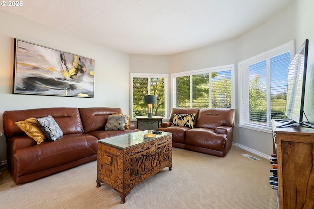 living room featuring light carpet and baseboards
