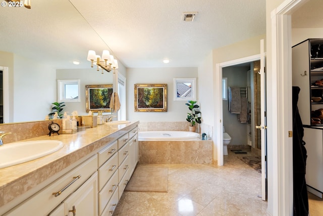 full bathroom with toilet, a bath, double vanity, tile patterned floors, and a spacious closet
