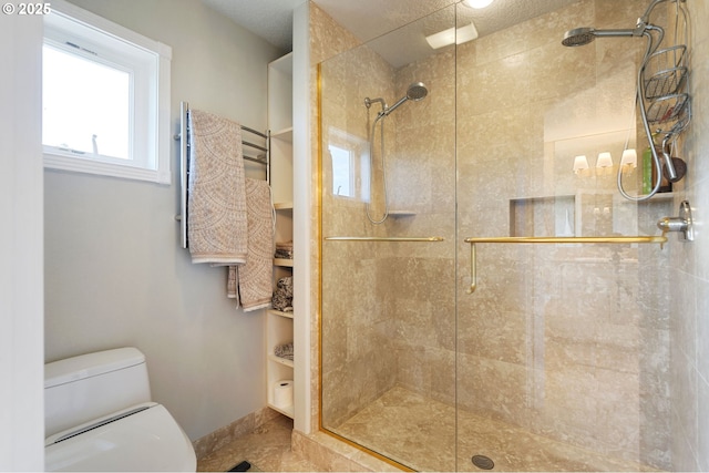 full bathroom with a shower stall, toilet, and baseboards