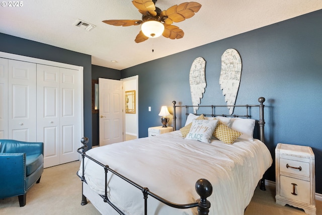 bedroom with light carpet, a closet, and ceiling fan